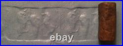 Ancient Sumerian brown stone cylinder seal with animal contest scene